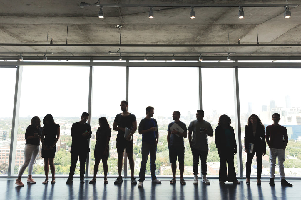 People gathered beside the windows in an office